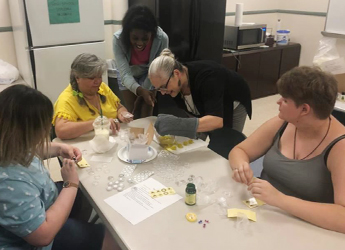  YOU participants craft homemade candles with their mentor.